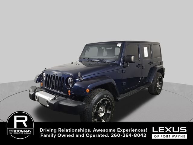 2013 Jeep Wrangler Unlimited Sahara in True Blue Pearlcoat — front three-quarter view